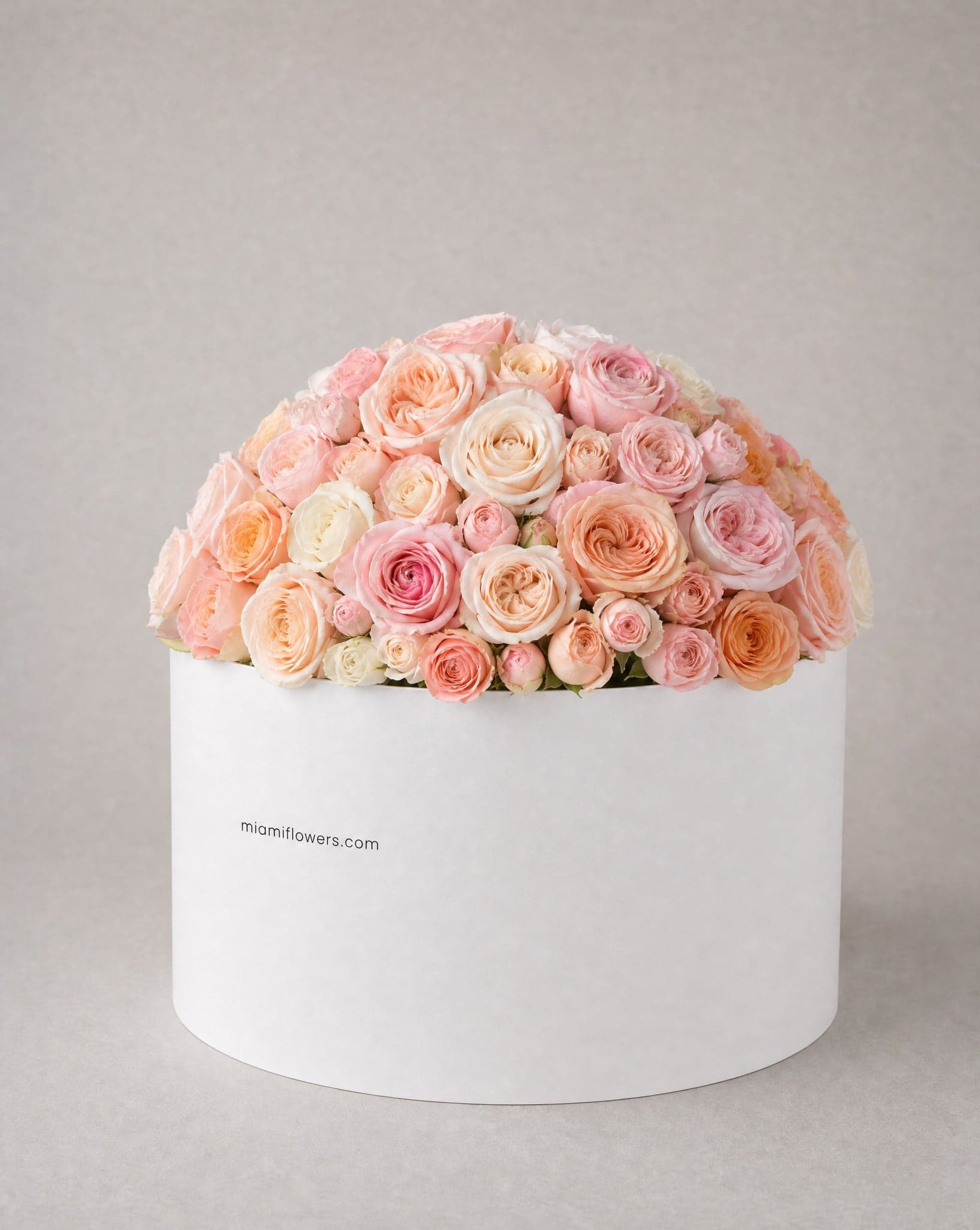 Roses in an oval box printed with miamiflowers.com