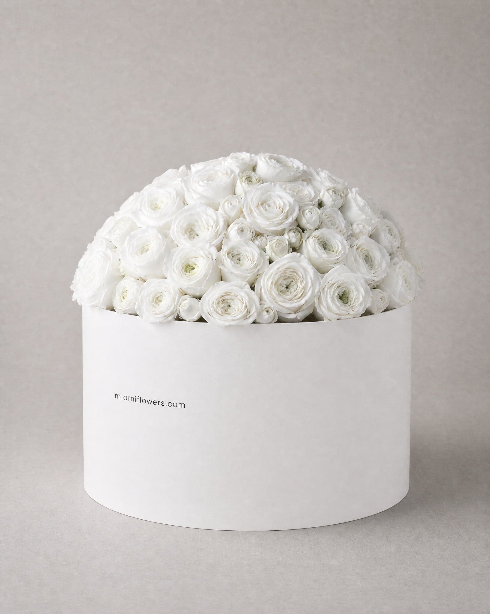 Roses in an oval box printed with miamiflowers.com