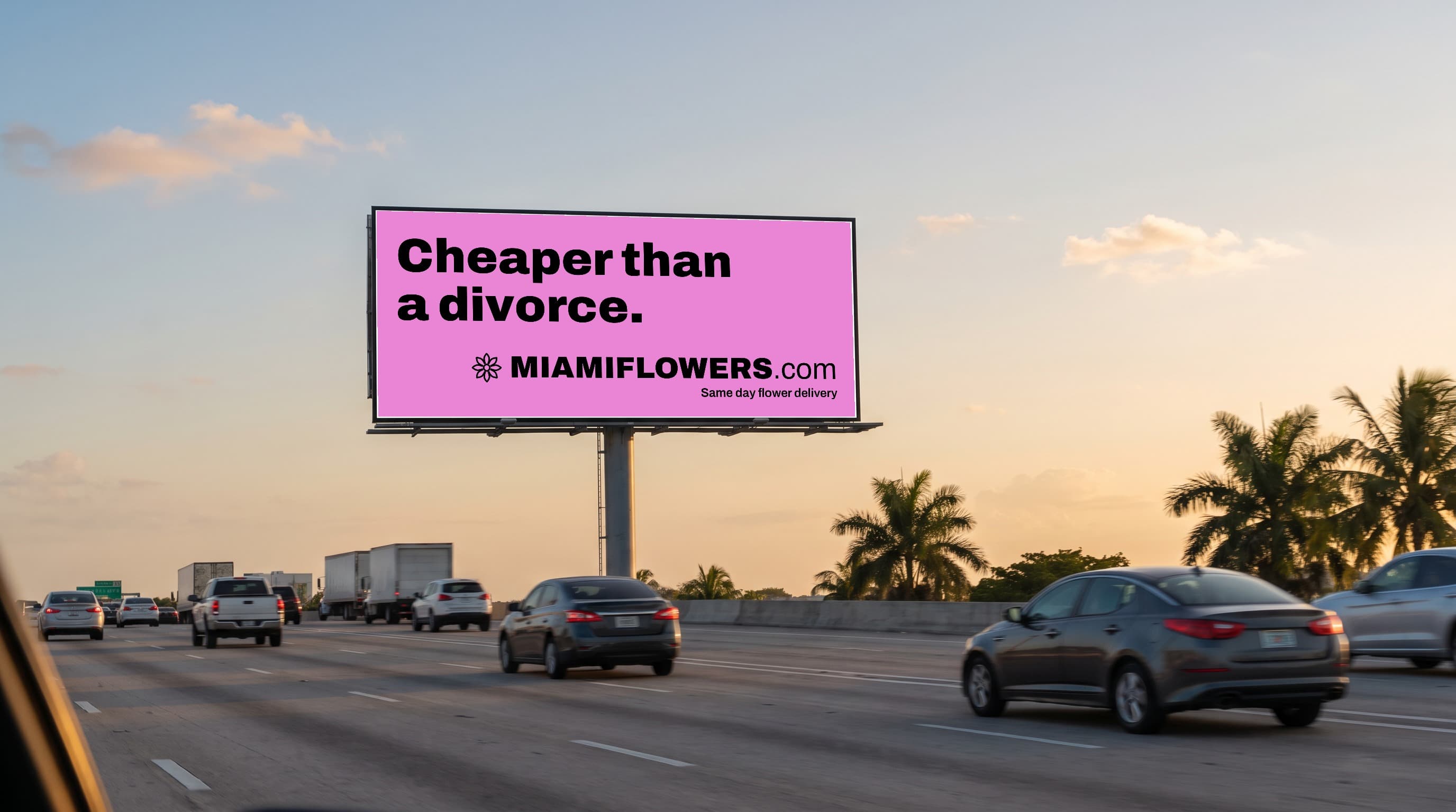 Pink MIAMIFLOWERS.com billboard over I-95 at sunset reading 'Cheaper than a divorce. Same day flower delivery.'